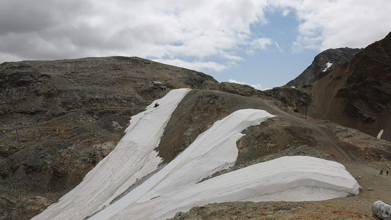 Bâches blanches déroulées sur la neige à la Diavolezza, dans les Alpes suisses, en juillet 2023